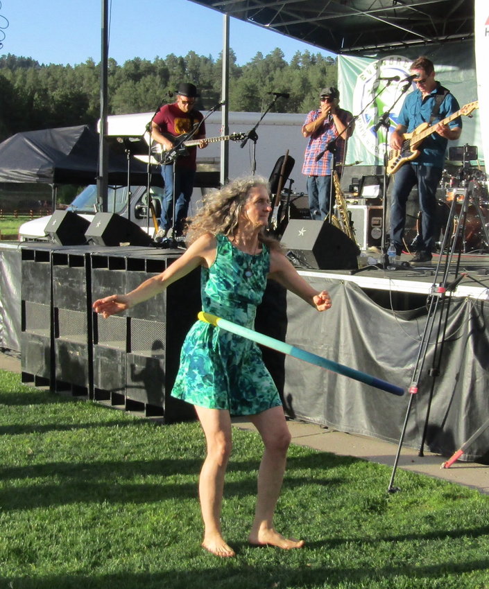 Jennie Glenn of Pine dances using a hula hoop to Dr. Poz & Friends at the first Evergreen Lake Concert on June 22.
